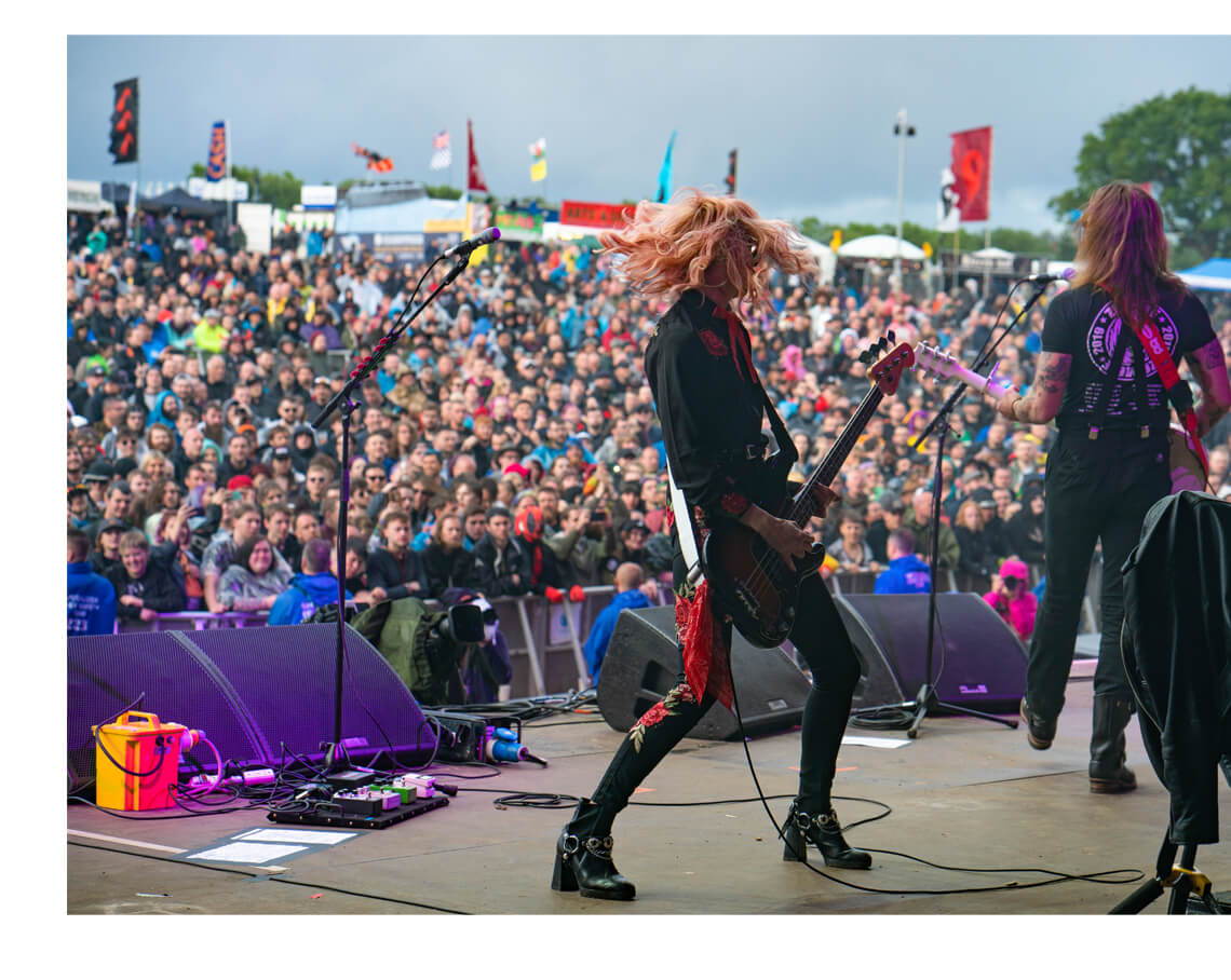 Jennie Vee on stage performing wearing her Jennie Vee collaboration sunglasses by Valley Eyewear